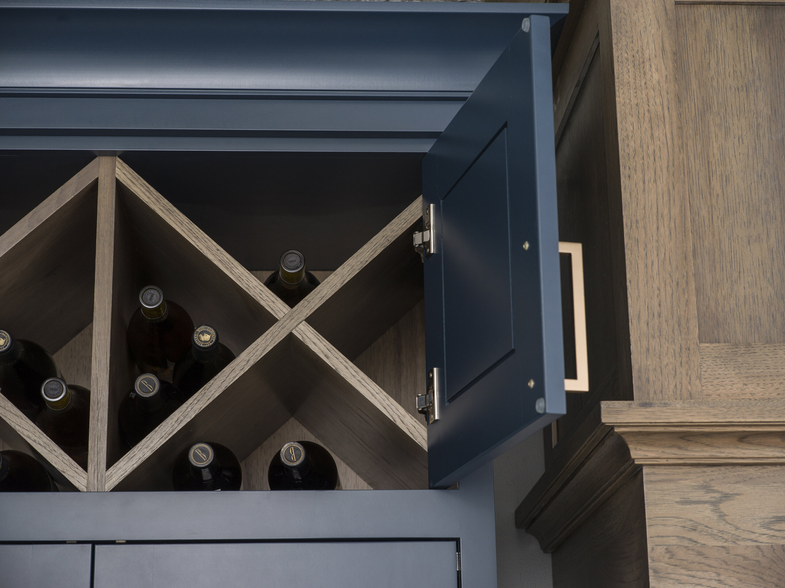 “X” Wall Wine Cube behind cabinet doors from Dura Supreme Cabinetry